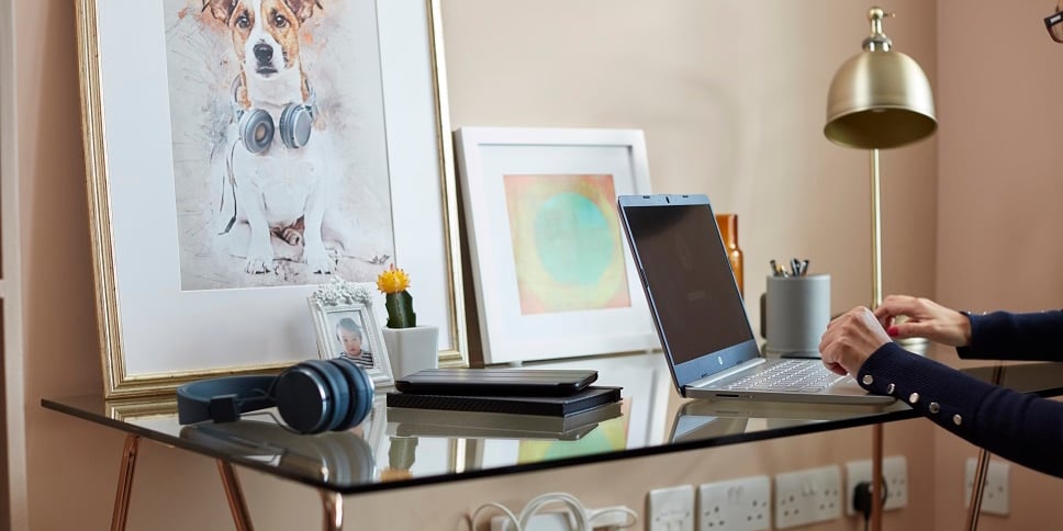 Customer sat at desk with home contents displayed